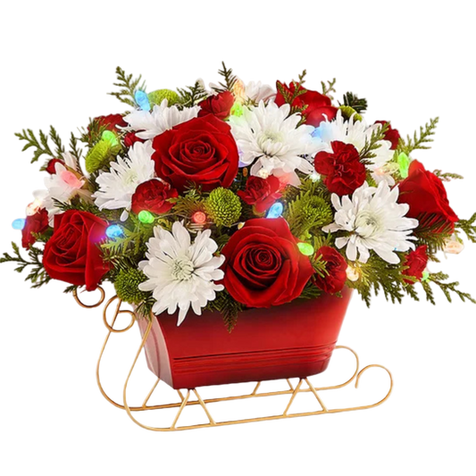 Floral arrangement with red and white flowers in a sleigh on a white background