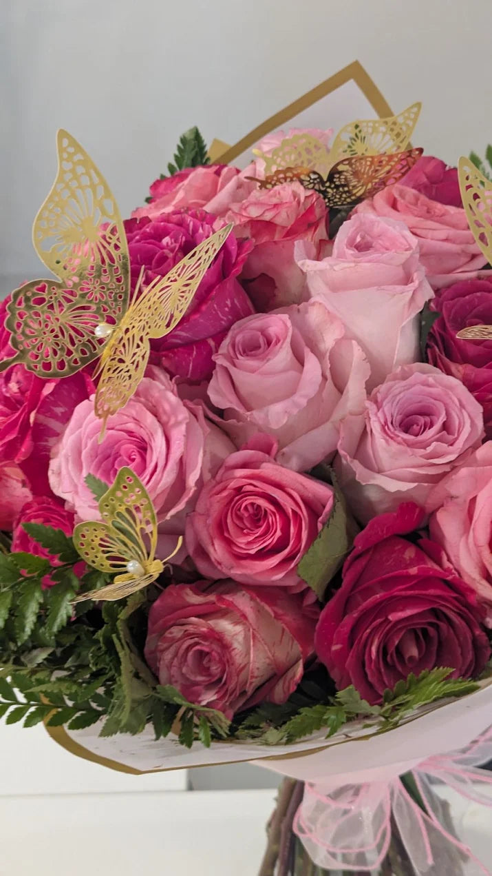 Pink rose bouquet in four shades with gold filigree butterflies, wrapped at Flauraly